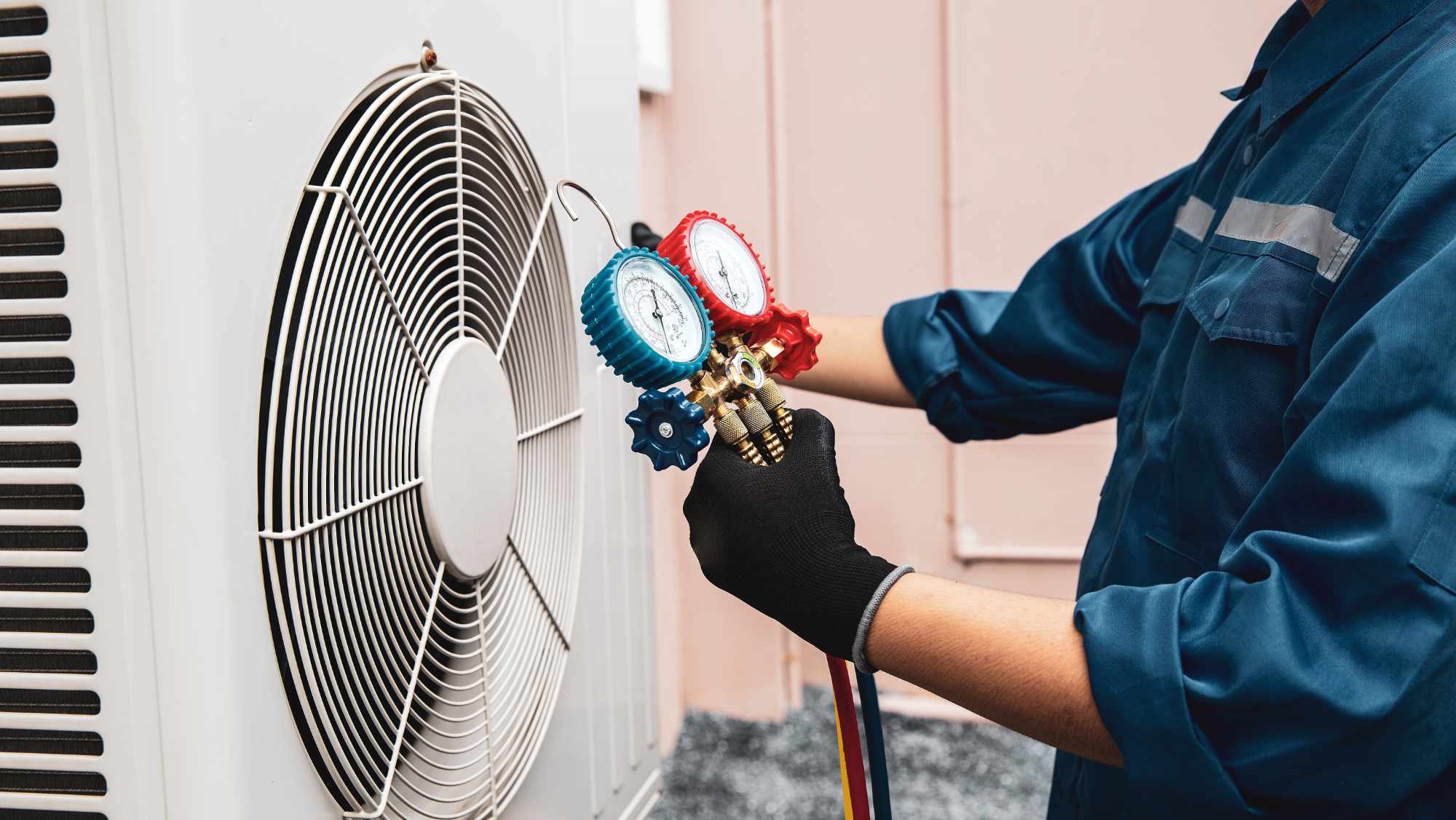 Heat and Air Conditioning, HVAC system service technician using measuring manifold gauge checking refrigerant and filling industrial air conditioner after duct cleaning maintenance outdoor compressor.